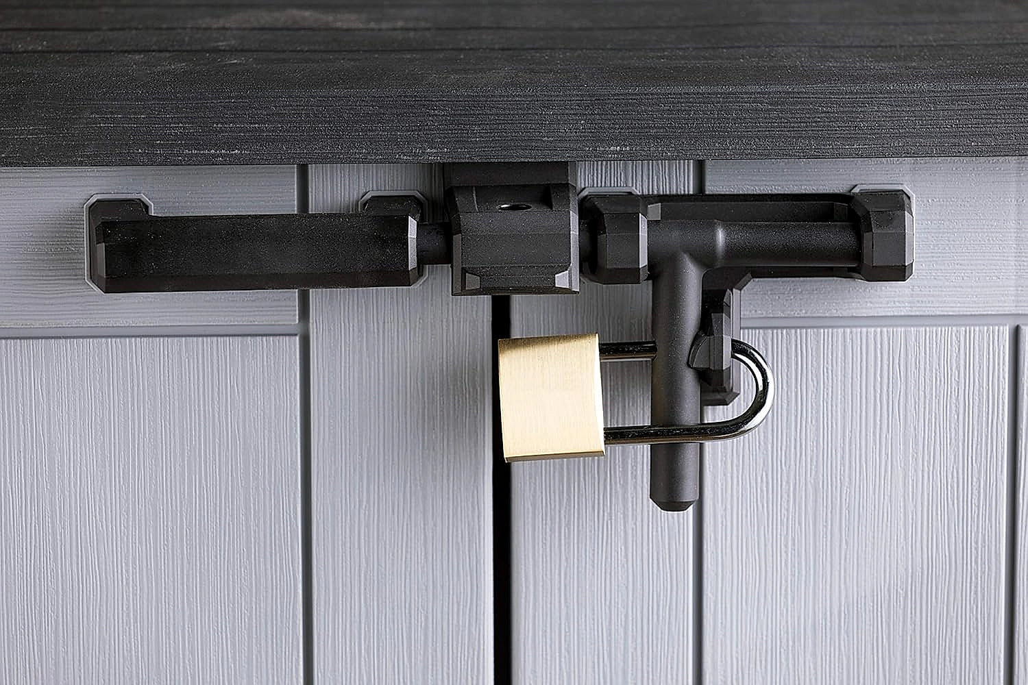 Keter Store It Out Nova storage shed placed in a backyard garden setting