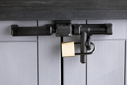 Keter Store It Out Nova storage shed placed in a backyard garden setting