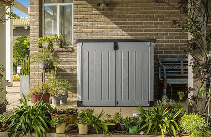 Front view of the Keter Store It Out Pro storage shed open with garden tools inside